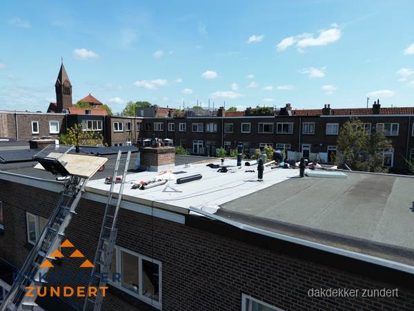 Dakdekkers aan het werk op plat dak in Zundert Dakdekkers aan het werk op plat dak in Zundert